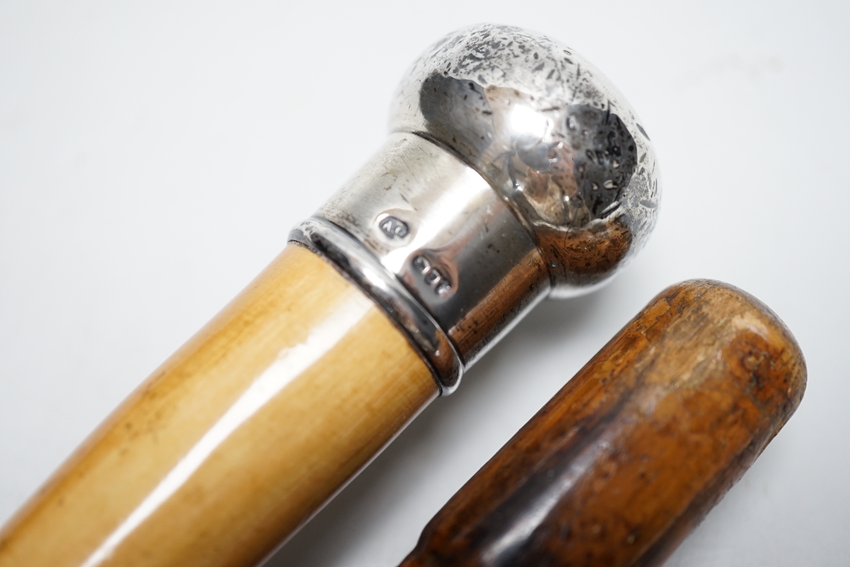 A Victorian sword stick and a silver topped walking cane